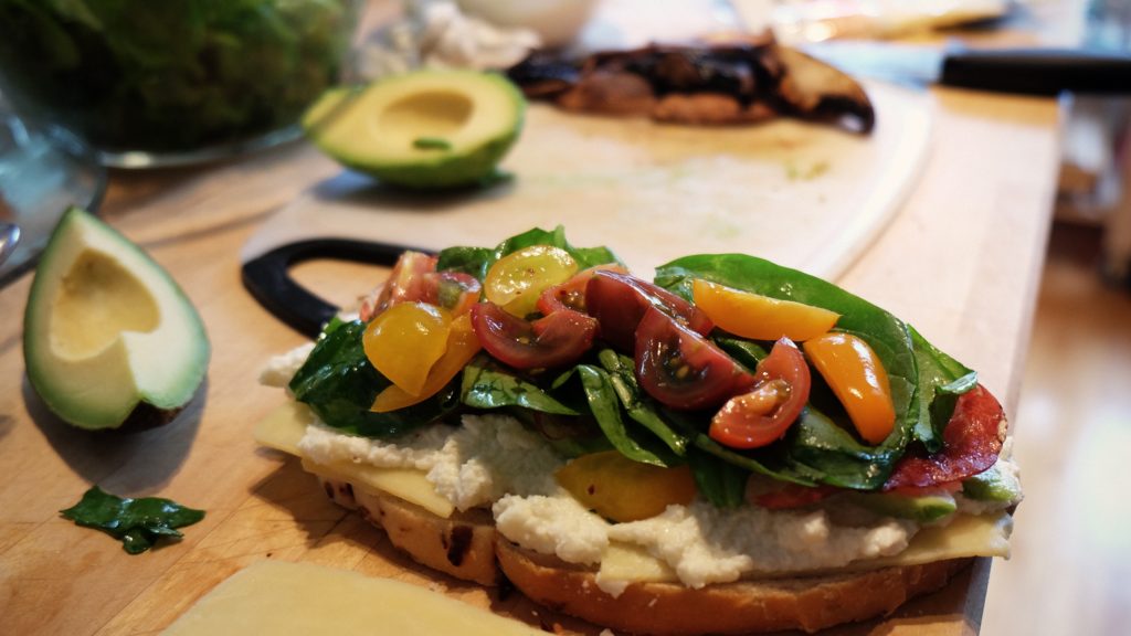 bread with Cashew spread topped with marinated salad and cocktail tomatoes